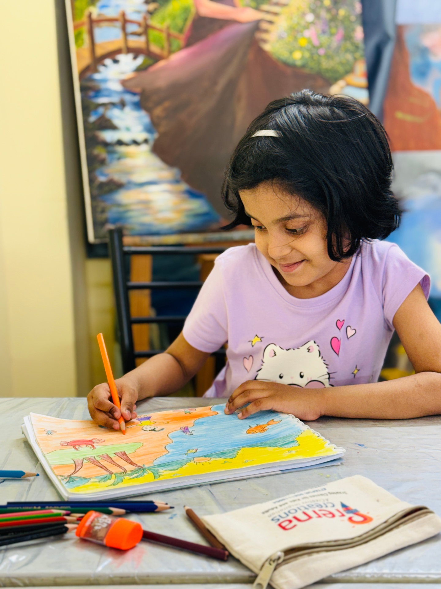 A young student painting on canvas at Prerna Creations studio in Attapur